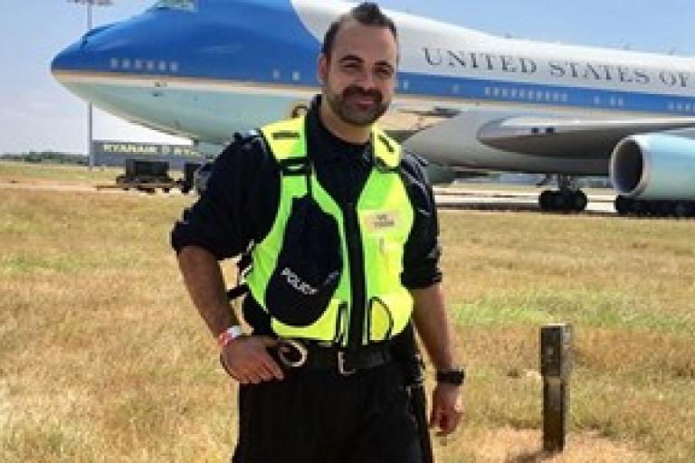 A police officer standing in front of an aeroplane
