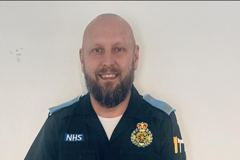 a male paramedic smiling 