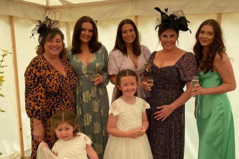 Group shot of a family of women and girls in dresses.